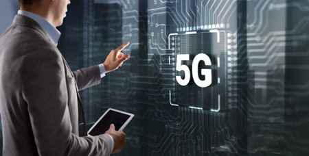 Digital 5G and Internet Telecommunication concept on circuit board. Man clicking on a virtual screenの写真素材