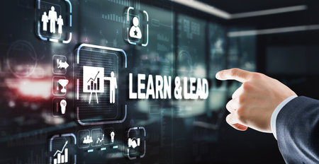 Learn and Lead. Businessman presses hand on the virtual screen inscriptionの写真素材