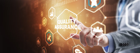 QA Businessman pressing Quality assurance button on virtual screensの写真素材