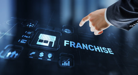 Businessman hand touching inscription Franchise marketing systemの写真素材