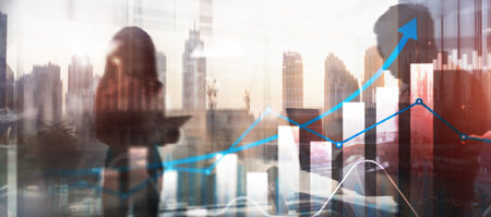 Graph showing financial growth, against a blurred city skyline background. Business city background. Mixed media.の写真素材
