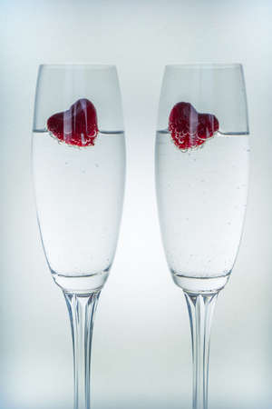 Valentines day background with champagne glasses and red heartsの写真素材