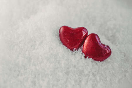 Valentines day; Two red hearts on othe snow. Holidays cardの写真素材
