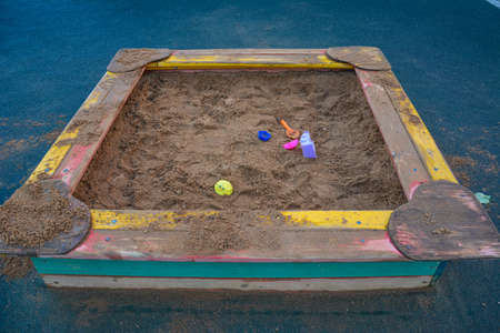 Sandbox with toys on the children's playground in the courtyard. Copy spaceの写真素材