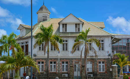 Le Francois, Martinique - September 18, 2018: Hotel de Ville, City Hall - an old building palm trees under a blue sky with white clouds. Copy spaceのeditorial素材