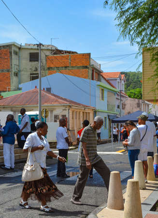 Sainte Anne, Martinique - Sept 19, 2018: Local people on a beautiful colorful street in Sainte Anne, Martiniqueのeditorial素材