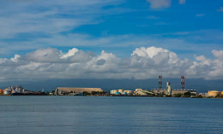 Point-a-Pitre, Guadeloupe - Sept 17, 2018: Cargo ship docked in the port of Pointe-a-Pitre in Guadeloupe. Blue sky with white clouds. Copy spaceのeditorial素材