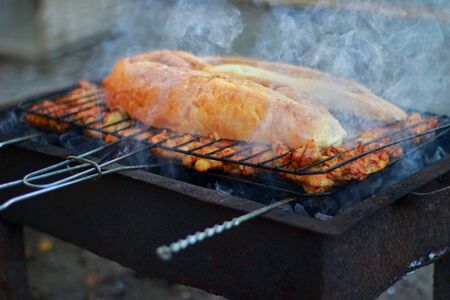 chicken meat and bread on barbecue