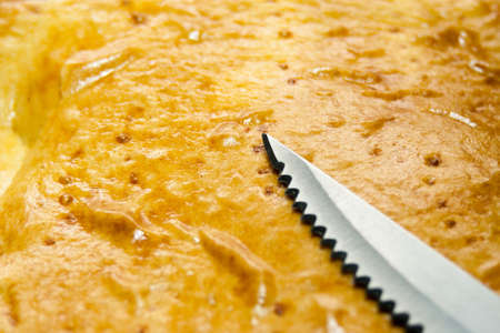 A piece of homemade apple pie on a plate with a knifeの写真素材