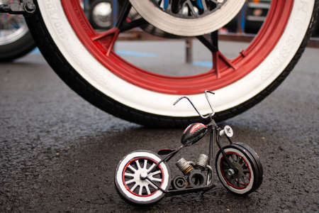A motorcycle model with a real motorcycle in the background.の写真素材