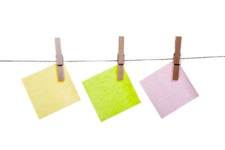 Blank paper cards hanging on clothespinsの写真素材