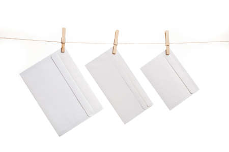 Three envelope held by clothespins on a stringの写真素材