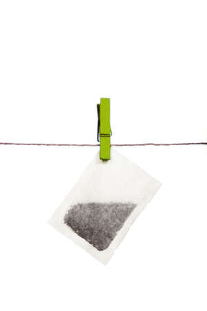 Teabag on a string, held by a clothespin の写真素材