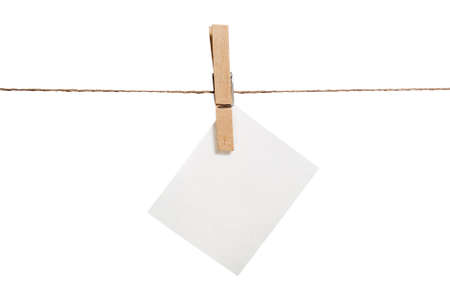 Close up of a note and a clothespin on white backgroundの写真素材