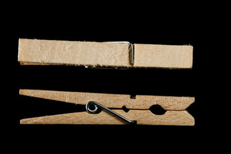 Two clothespins on black backgroundの写真素材