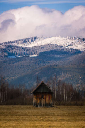 Lonley wooden hut at the foot of the mountainの写真素材