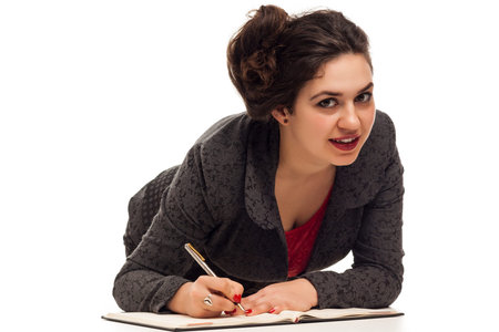 Confident business woman portrait  with notebook isolated over a white の写真素材
