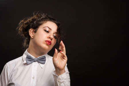 confident stylish woman playing with her hairの写真素材