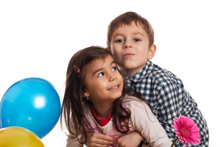 boy hugging girl with flower and balloons on white backgroundの写真素材
