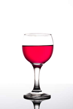 Classy colrfull backlit red vine glass with reflectionの写真素材
