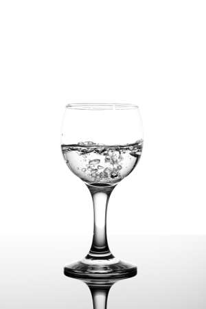 transparent glass with fizzy water on white backgroundの写真素材