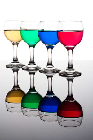 red, green, yellow and blue backlit drinks with reflectionの写真素材
