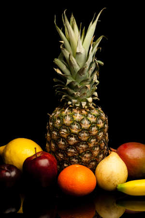 bunch of exotic fruits on black background with reflectionの写真素材