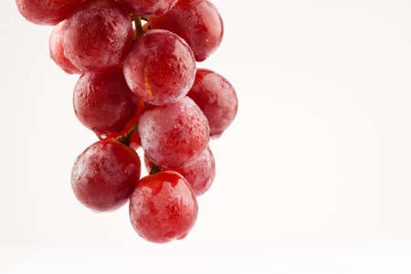 fresh rose grapes with waterdrops on white backgroundの写真素材
