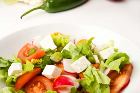 vegetable salad close up in a white bowlの写真素材