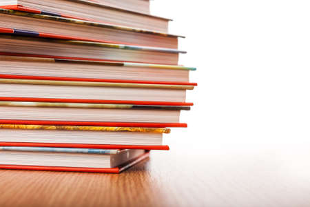 Pile of different books put on a wooden tableの写真素材