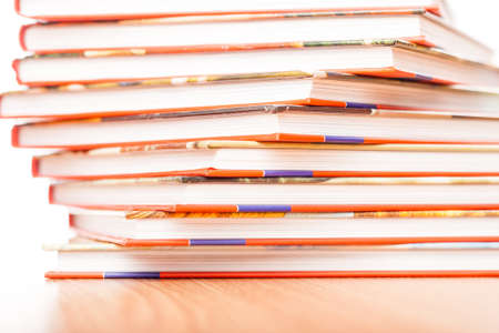 Pile of different books put on a wooden tableの写真素材