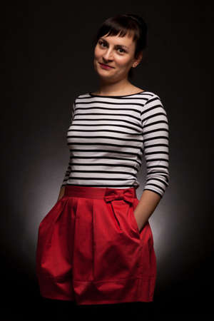 stylish expressive woman with red trousers on black backgroundの写真素材