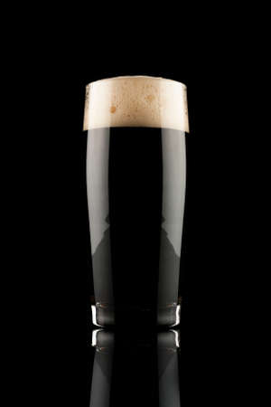 glass of black beer with reflectionの写真素材