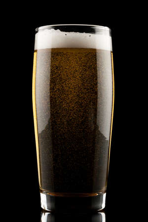 back lit glass of beer with reflectionの写真素材
