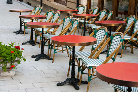 red elegant restaurant tables with chairs placed outdoorsの写真素材