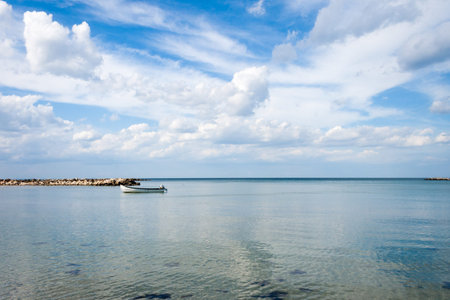 sea with boat and sky whit clouds landscape on summer dayの写真素材