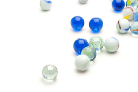 photo of different color marbles on whiteの写真素材