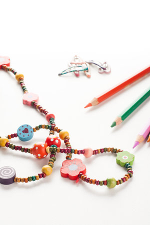 colorful little girl accessories, necklace, hairpins, pencilsの写真素材