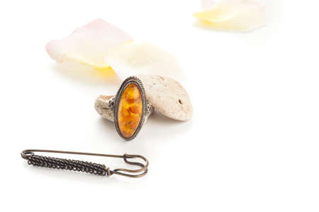 vintage orange ring with stones and rose petalsの写真素材