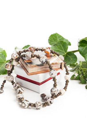 beautiful necklace with box and little book and green leafsの写真素材