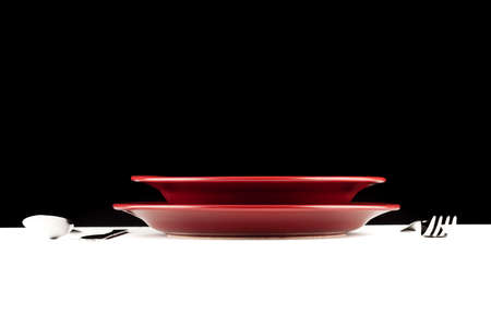 simple table setting with white table and black backgroundの写真素材