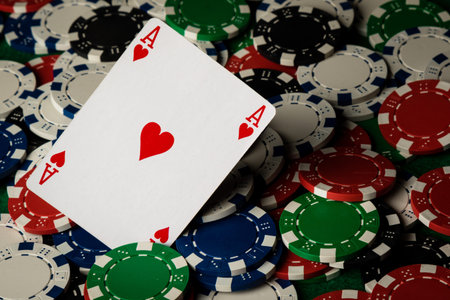 Ace of hearts on many poker chips spread on table