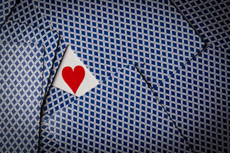 poker cards spread on table with a heart showingの写真素材