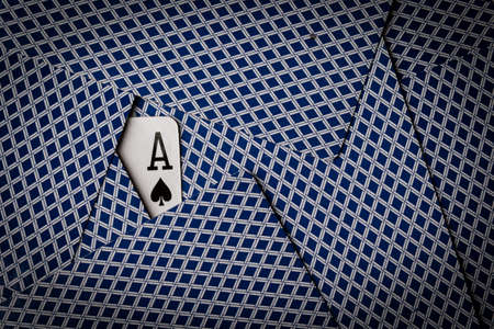 poker cards spread on table with ace of spades showingの写真素材