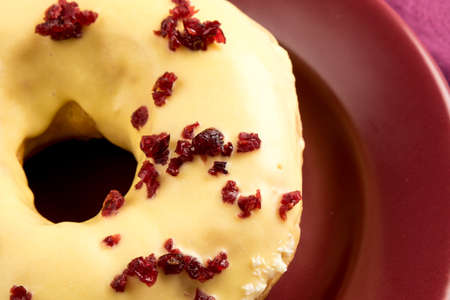 doughnut with cherry on marsala color plateの写真素材