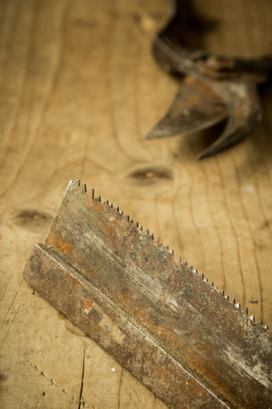 old used rusty saw blade on wooden table