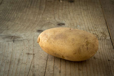 fresh natural organic potato on wooden tableの写真素材