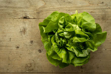 fresh organic green salad on wooden tableの写真素材