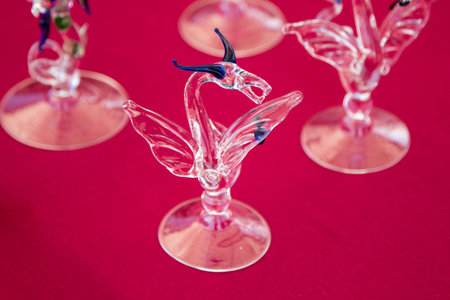 decorative small glass dragon on red tableの写真素材
