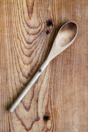 old wood spoon on a wooden tableの写真素材